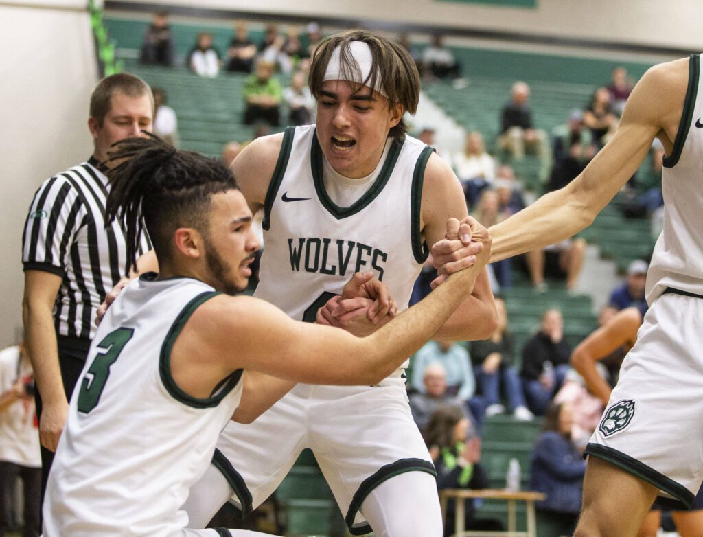 Jackson’s Drew Pepin cheers on his teammate Trey Hawkins after he draws a foul during the game against Arlington on Tuesday, Nov. 28, 2023 in Everett, Washington. (Olivia Vanni / The Herald)
