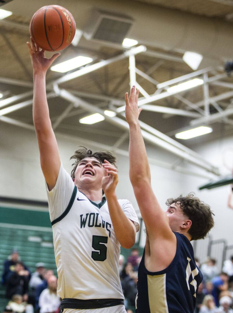 Jackson’s Henry Johnson makes a layup during the game against Arlington on Tuesday, Nov. 28, 2023 in Everett, Washington. (Olivia Vanni / The Herald)

