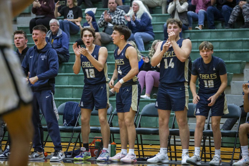 The Arlington bench react to a score during the game against Jackson on Tuesday, Nov. 28, 2023 in Everett, Washington. (Olivia Vanni / The Herald)
