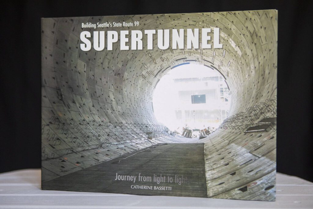 Catherine Bassetti’s book “Building Seattle’s State Route 99 Supertunnel: Journey from Light to Light” in her home studio in Shoreline, Washington on Friday, May 19, 2023. (Annie Barker / The Herald)
