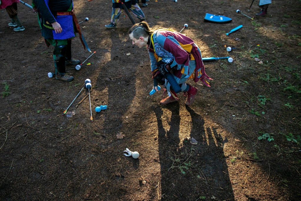 A player snags an ice spell from the ground during a warmup round of “heavy object” at a weekly meeting of the Amtgard LARPing group The Hollow on Jan. 29, at McCollum Park. (Ryan Berry / The Herald)
