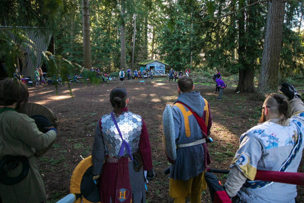 Team Hybris A, foreground, stare down Team Wren before a round of “ring the bell” during a weekly meeting of the Amtgard LARPing group The Hollow on Jan. 29, at McCollum Park. (Ryan Berry / The Herald) 
