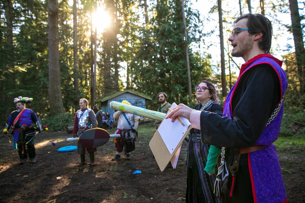 Charlie Heberer, persona Kulos, explains the details of a 4v4 Ring The Bell tournament during a weekly meeting of the Amtgard LARPing group The Hollow on Jan. 29, at McCollum Park. (Ryan Berry / The Herald)
