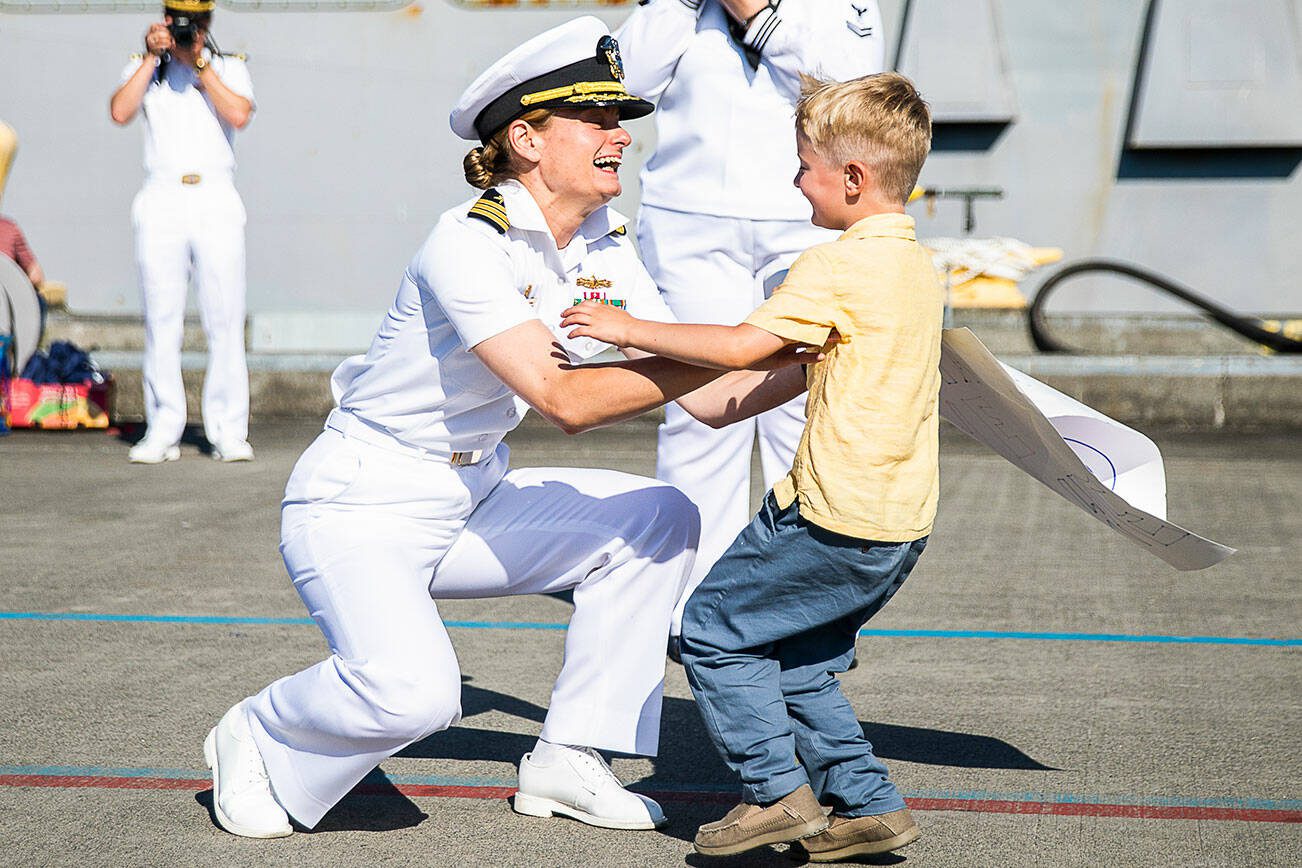 Commanding Officer Meghan Bodnar is greeted by her son Grady, who hasn’t seen her in 224 days, at Naval Station Everett on Thursday, Aug. 11, 2022 in Everett, Washington. (Olivia Vanni / The Herald)