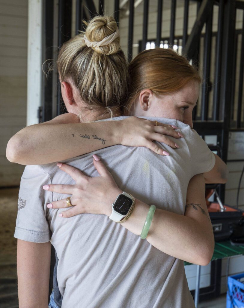 Kaisa and Shay Daniels hug and celebrate after learning Manny will survive at the Gifford Horses barn in Snohomish, Washington on Friday, June 23, 2023. (Annie Barker / The Herald)
