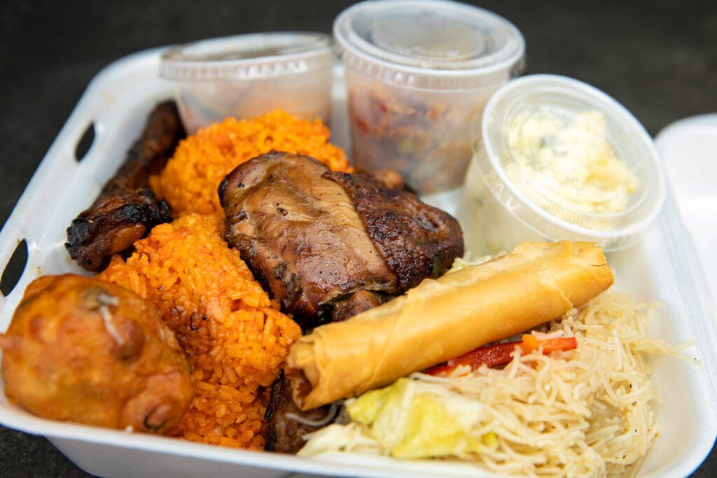 Guam Grub’s most popular dish, the Fiesta Plate, features a list of items including grilled pork ribs and chicken, red rice, pancit, chicken kelaguen and more at the Everett Mall. (Ryan Berry / The Herald)
