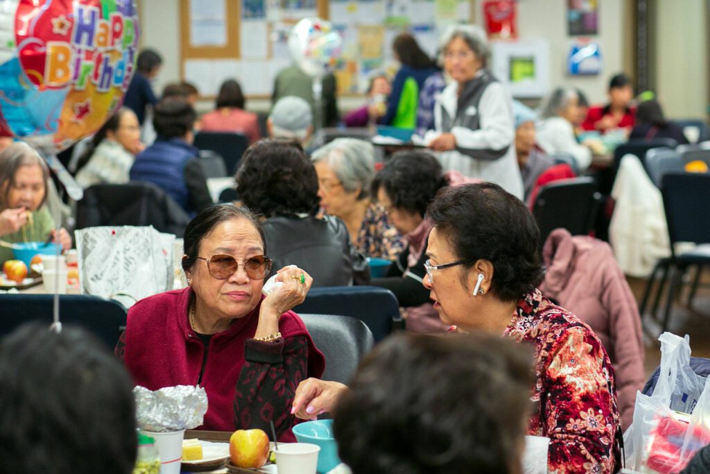 Vietnamese seniors gather and talk over a meal during a community lunch at the Homage Multicultural Senior Center on Wednesday, Nov. 15, 2023, in Lynnwood, Washington. (Ryan Berry / The Herald)
