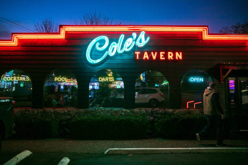 Classic neon-style lights illuminate the front of Cole’s Tavern. (Ryan Berry / The Herald)
