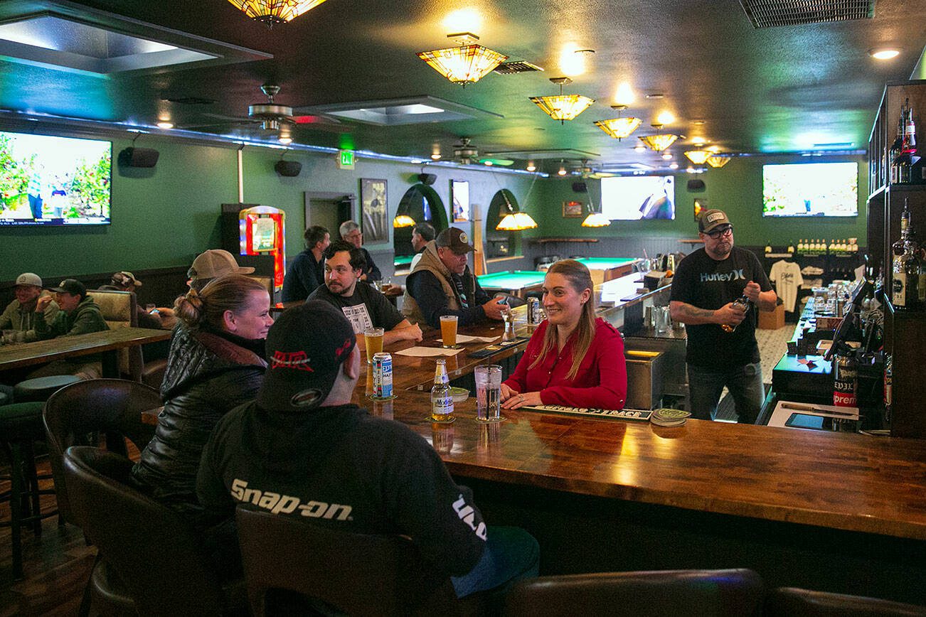 Britana Uppinghouse, who owns Cole’s Tavern with her husband Cole, chats with a couple newcomers at the bar on Wednesday, Nov. 15, 2023, in Mukilteo, Washington. (Ryan Berry / The Herald)