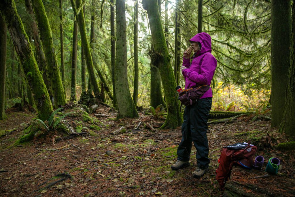 Alexis Burroughs summons participants back from the forest using an owl call during a forest bathing session Sunday, Nov. 19, 2023, at Lord Hill Regional Park near Snohomish, Washington. (Ryan Berry / The Herald)
