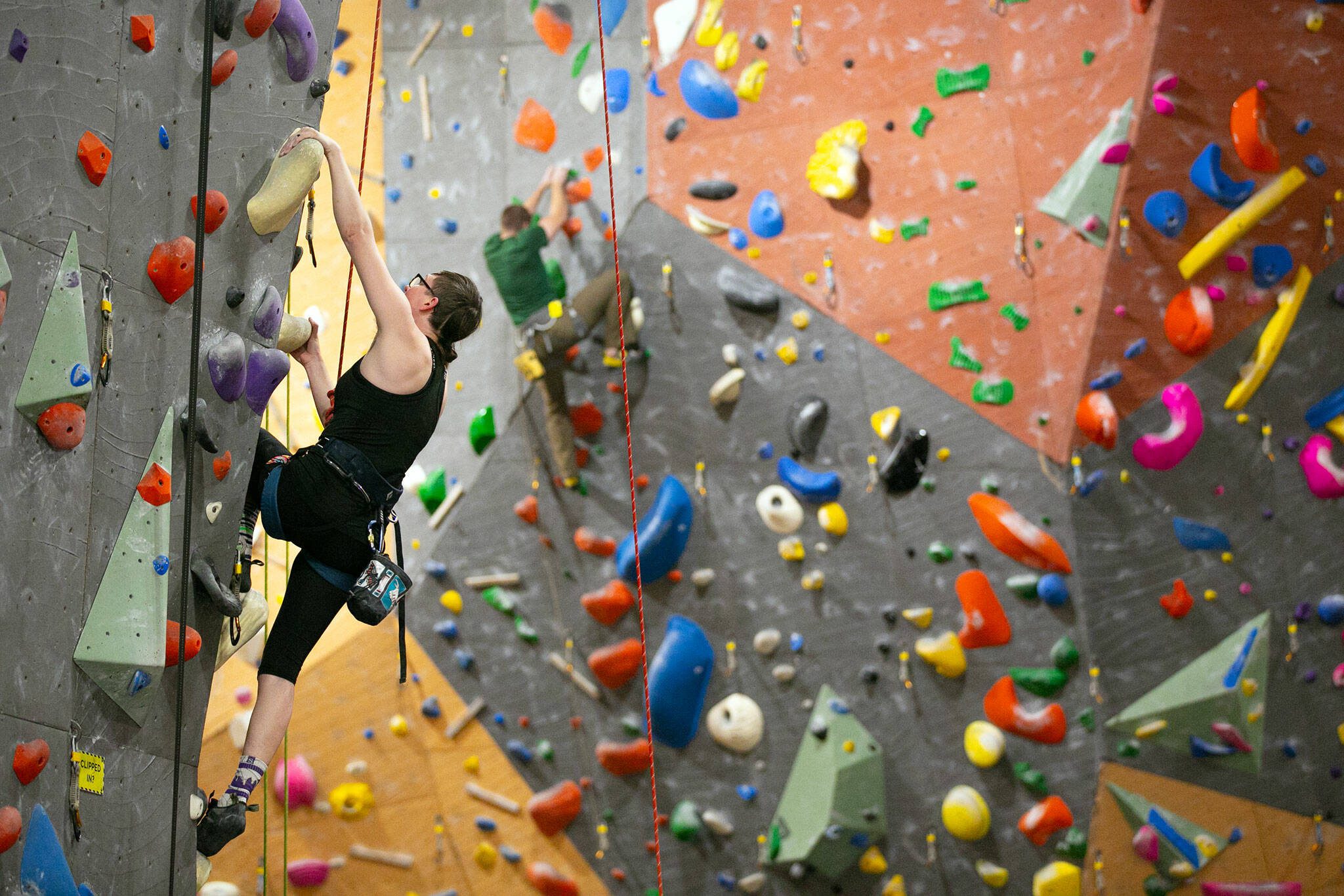 Lead climbers head up their respective routes at Vertical World North on Monday, Nov. 20, 2023, in Lynnwood, Washington. (Ryan Berry / The Herald)