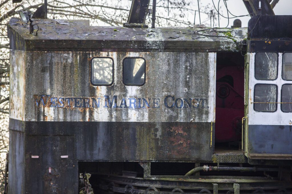 A company name is visible on the side of a derelict boat seen along Union Slough on Tuesday, Nov. 21, 2023 in Everett, Washington. (Olivia Vanni / The Herald)
