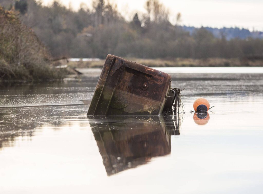 A large metal box floats in Ebey Slough on Tuesday, Nov. 21, 2023 in Everett, Washington. (Olivia Vanni / The Herald)
