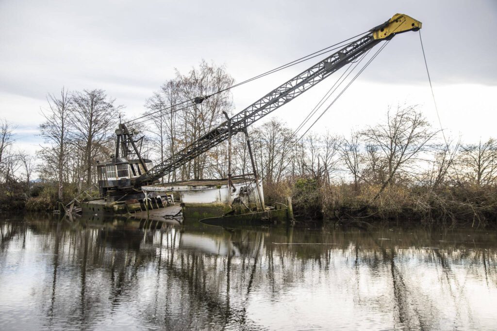 A derelict boat seen in Union Slough on Tuesday, Nov. 21, 2023 in Everett, Washington. (Olivia Vanni / The Herald)
