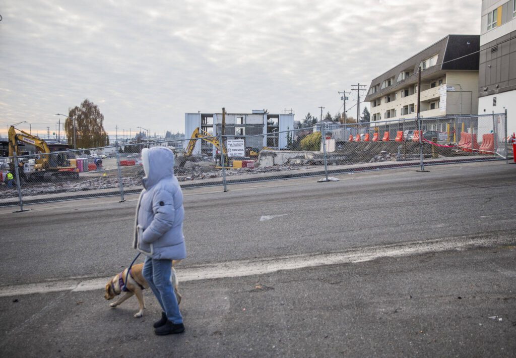 A person walks by the Broadway construction site of Compass Health’s new mental health facility on Wednesday, Nov. 29, 2023 in Everett, Washington. (Olivia Vanni / The Herald)
