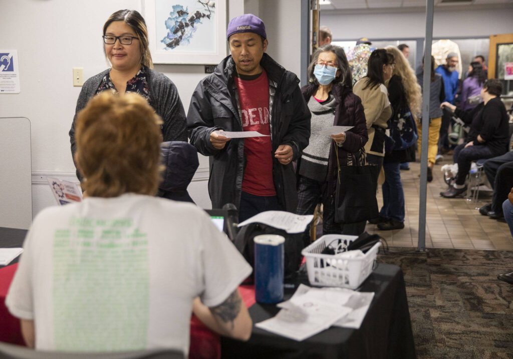 Dozens of people wait in line with items in need of repair at the Repair Cafe on Saturday, Nov. 18, 2023 in Mountlake Terrace, Washington. (Olivia Vanni / The Herald)
