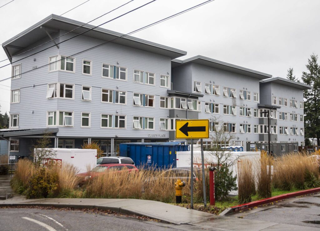 Storage containers and a dumpster sit in the parking lot outside of Clare’s Place on Monday, Dec. 4, 2023 in Everett, Washington. (Olivia Vanni / The Herald)
