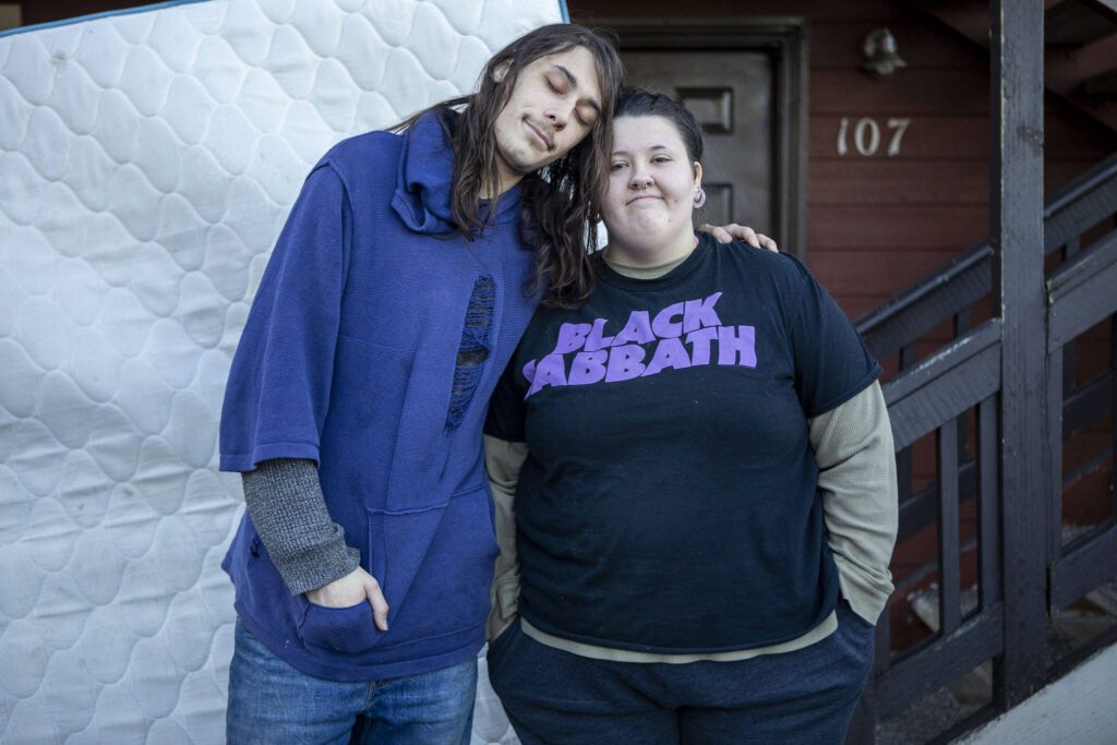 Gabriel McCollum, left, and Esther Key, right, pose for a photo at the Riverdale Apartments in Everett, Washington on Tuesday, Nov. 28, 2023. There was a shooting across the street on Sunday. (Annie Barker / The Herald)
