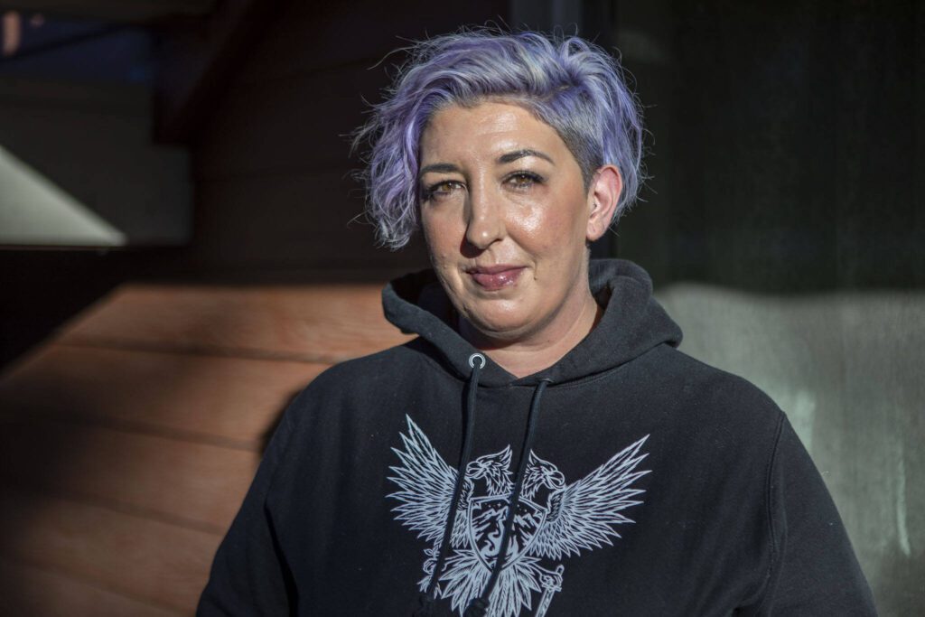 Christa Johnson poses for a photo at the Riverdale Apartments in Everett, Washington on Tuesday, Nov. 28, 2023. There was a shooting across the street on Sunday. (Annie Barker / The Herald)
