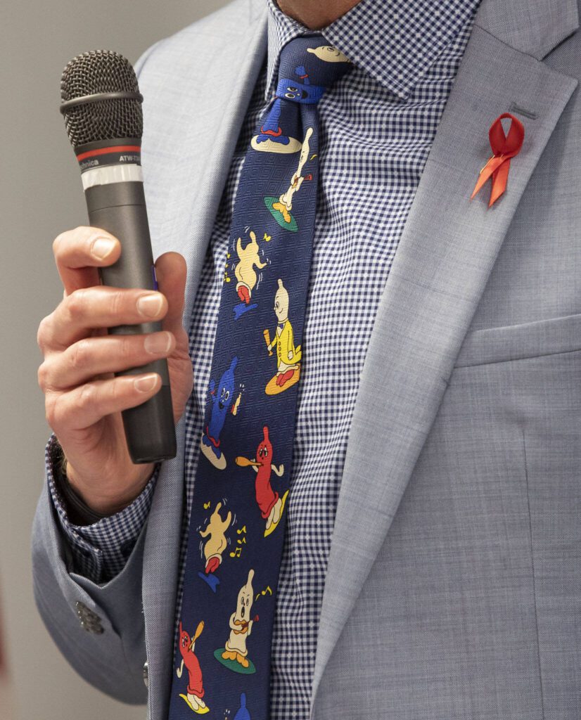 Health Department Director Dennis Worsham wears a condom-themed tie at a press conference held in celebration of the STI clinic opening on Friday, Dec. 1, 2023 in Everett, Washington. (Olivia Vanni / The Herald)
