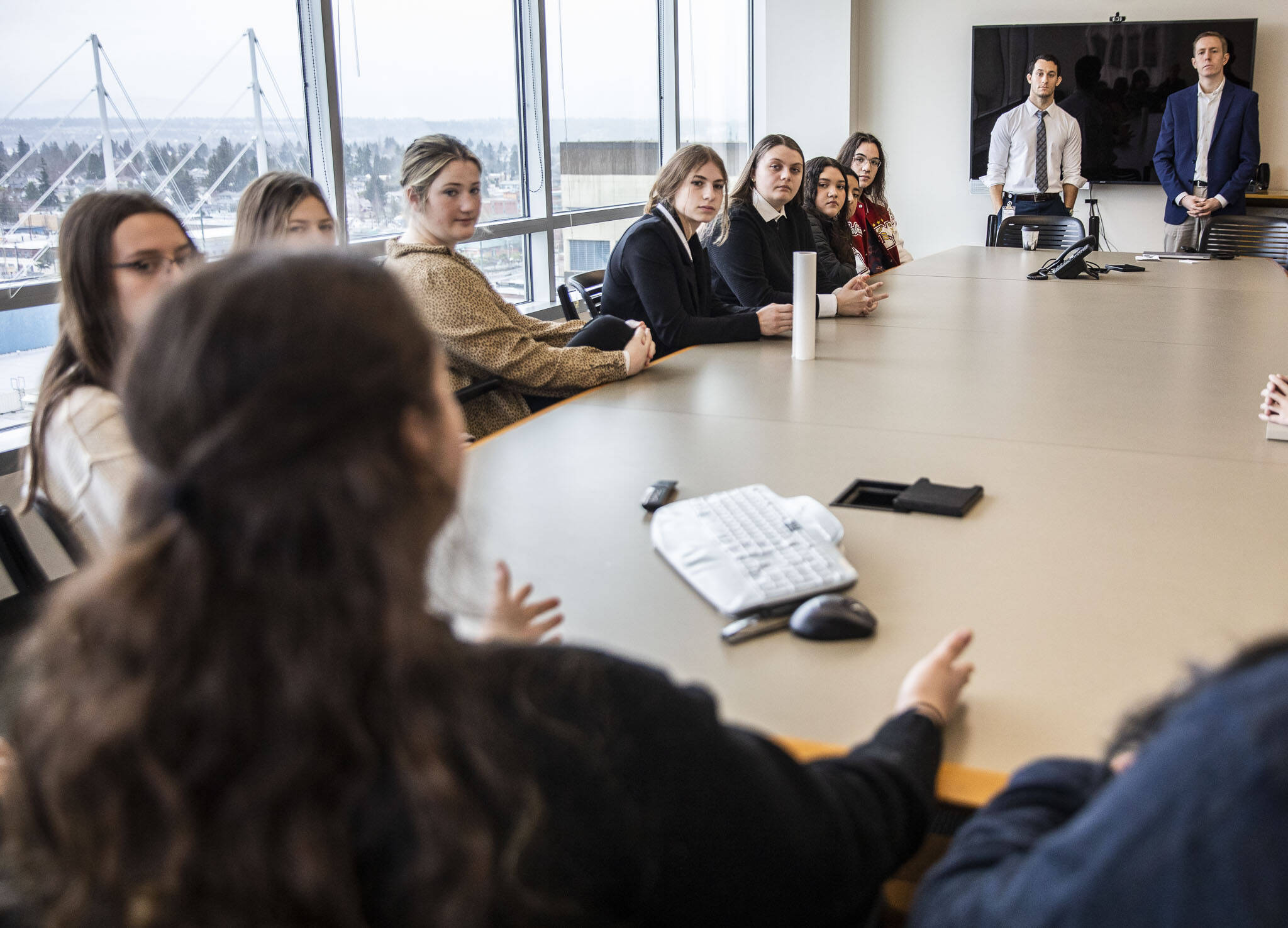 Snohomish County council members Jared Mead and Nate Nehring talk with Marysville Pilchuck High School students during a Civic Engagement Day event hosted at the county campus in Everett, Washington. On Dec. 4 the council members will host Building Bridges, an event that aims to create a space to discuss political polarization in a respectful way. (Olivia Vanni / The Herald)