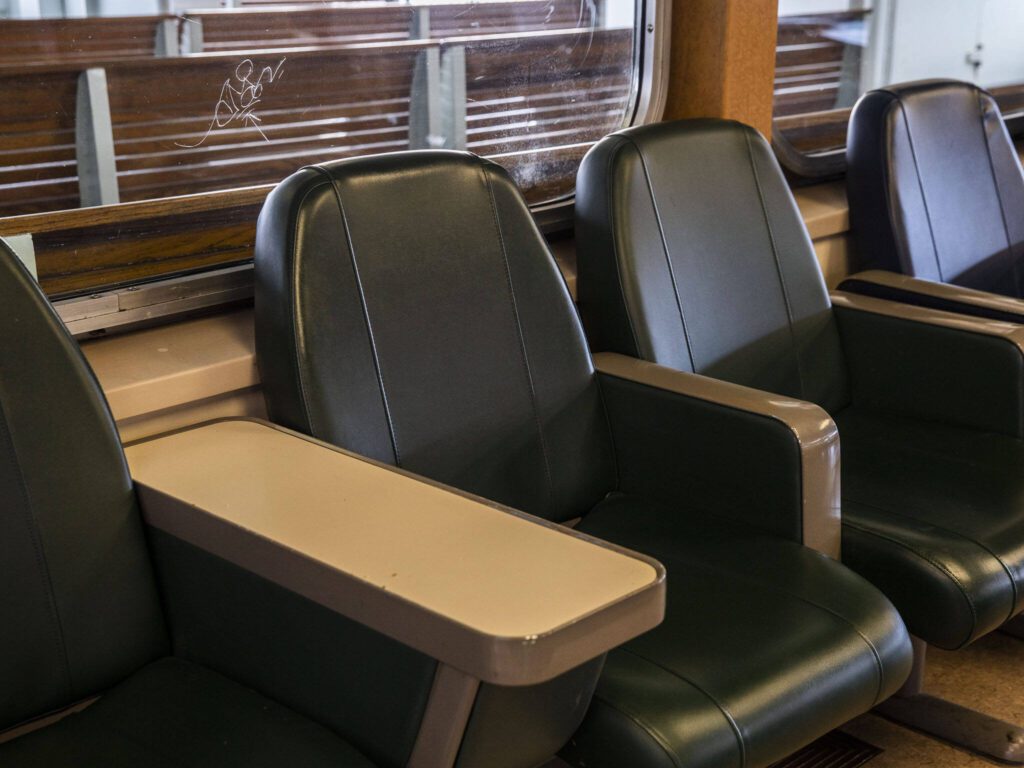 Graffiti is scratched into a window above a row of seats in the M/V Kitsap on Friday, Dec. 1, 2023 in Mukilteo, Washington. (Olivia Vanni / The Herald)
