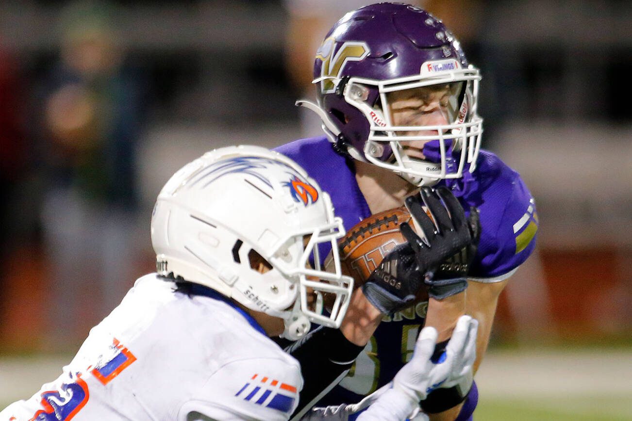 Lake Stevens’ David Brown snags a game-sealing interception in the fourth quarter of the 4A semifinal against Graham-Kapowsin on Saturday, Nov. 26, 2022, at Lake Stevens High School in Lake Stevens, Washington. (Ryan Berry / The Herald)