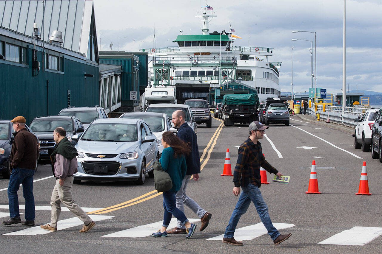 Offloading ferry traffic is stopped to allow pedestrians to cross the street at the Edmonds ferry dock on Friday, Sept. 21, 2018, in Edmonds. (Andy Bronson / The Herald)