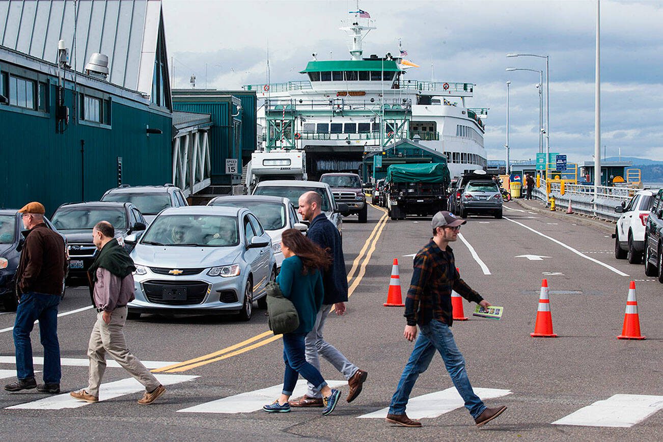 Offloading ferry traffic is stopped to allow pedestrians to cross the street at the Edmonds ferry dock on Friday, Sept. 21, 2018 in Edmonds. (Andy Bronson / The Herald)