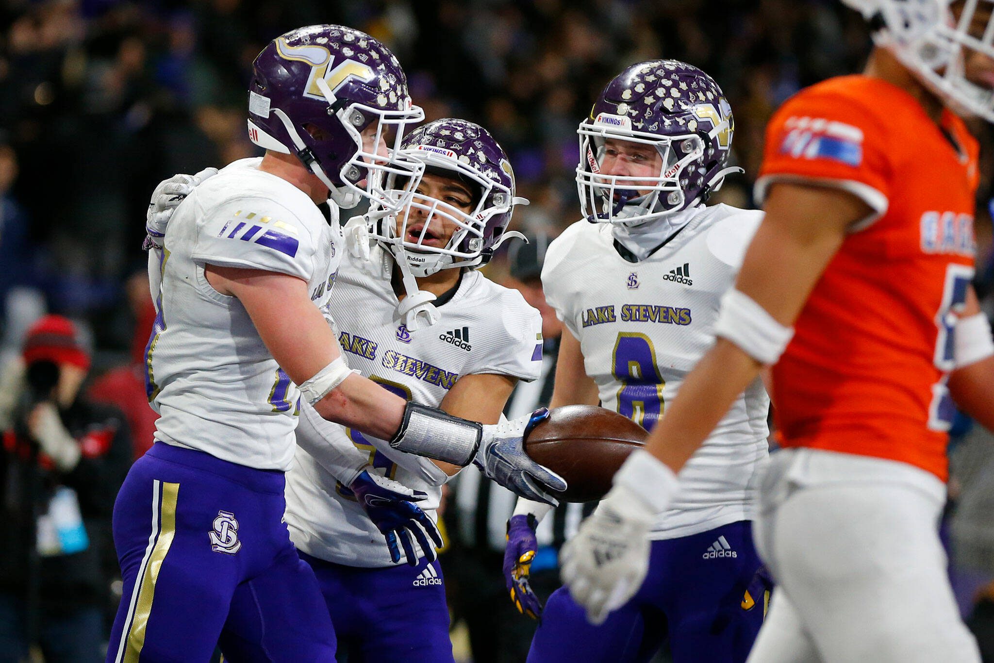 Lake Stevens players celebrate Jesse Lewis’ second-half touchdown against Graham-Kapowsin during the Class 4A state championship on Saturdayat Husky Stadium in Seattle. (Ryan Berry / The Herald)