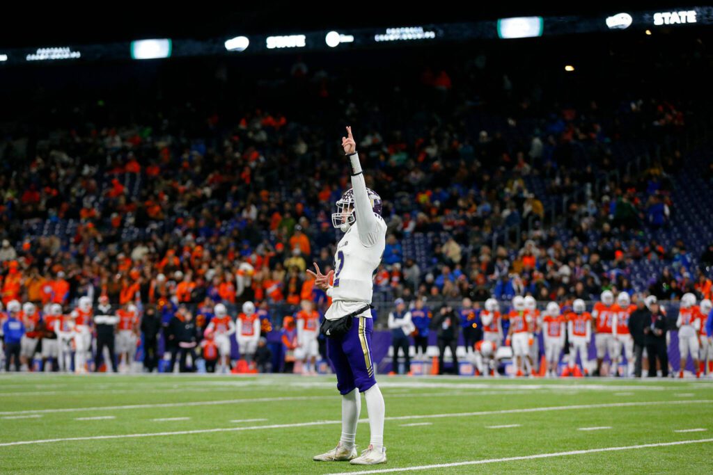 Lake Stevens junior quarterback Kolton Matson turns to the Lake Stevens crowd and celebrates after throwing a touchdown against Graham-Kapowsin during the WIAA 4A Football State Championship on Saturday, Dec. 2, 2023, at Husky Stadium in Seattle, Washington. (Ryan Berry / The Herald)
