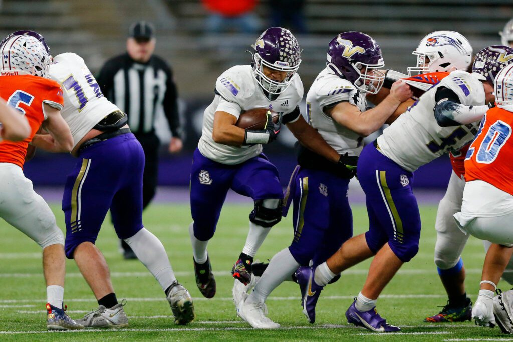 Lake Stevens’ Jayshon Limar finds a hole in the line on a handoff against Graham-Kapowsin during the WIAA 4A Football State Championship on Saturday, Dec. 2, 2023, at Husky Stadium in Seattle, Washington. (Ryan Berry / The Herald)
