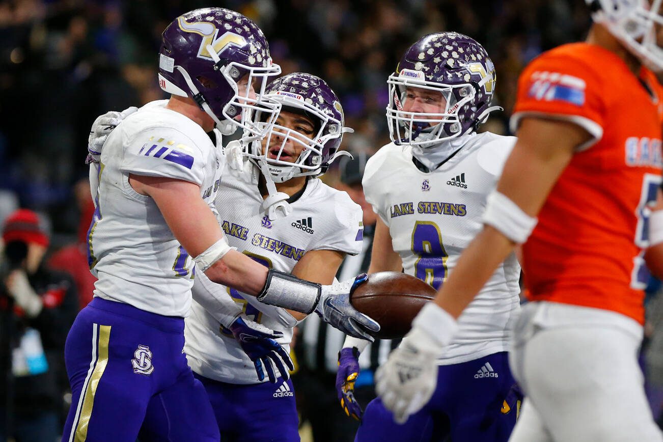 Lake Stevens players celebrate Jesse Lewis’ second-half touchdown against Graham-Kapowsin during the WIAA 4A Football State Championship on Saturday, Dec. 2, 2023, at Husky Stadium in Seattle, Washington. (Ryan Berry / The Herald)