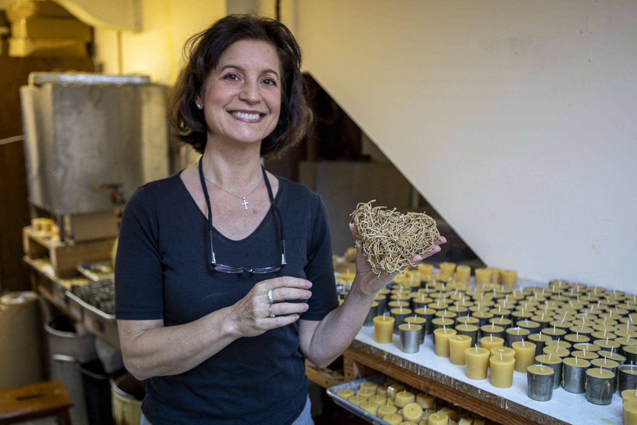 Katherine Hopke poses for a photo in her studio for Golden Light Beeswax Candles at her home in Everett, Washington on Thursday, Nov. 30, 2023.  (Annie Barker / The Herald)