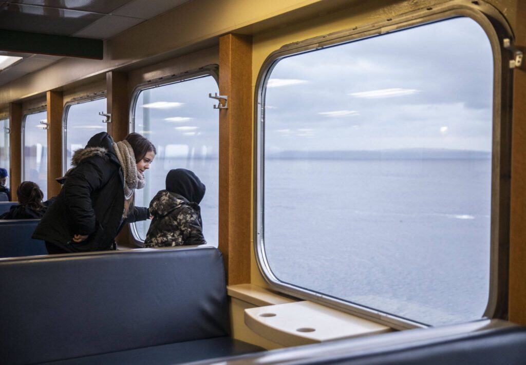 People look out the window from inside the M/V Kitsap on Friday, Dec. 1, 2023 in Everett, Washington. (Olivia Vanni / The Herald)
