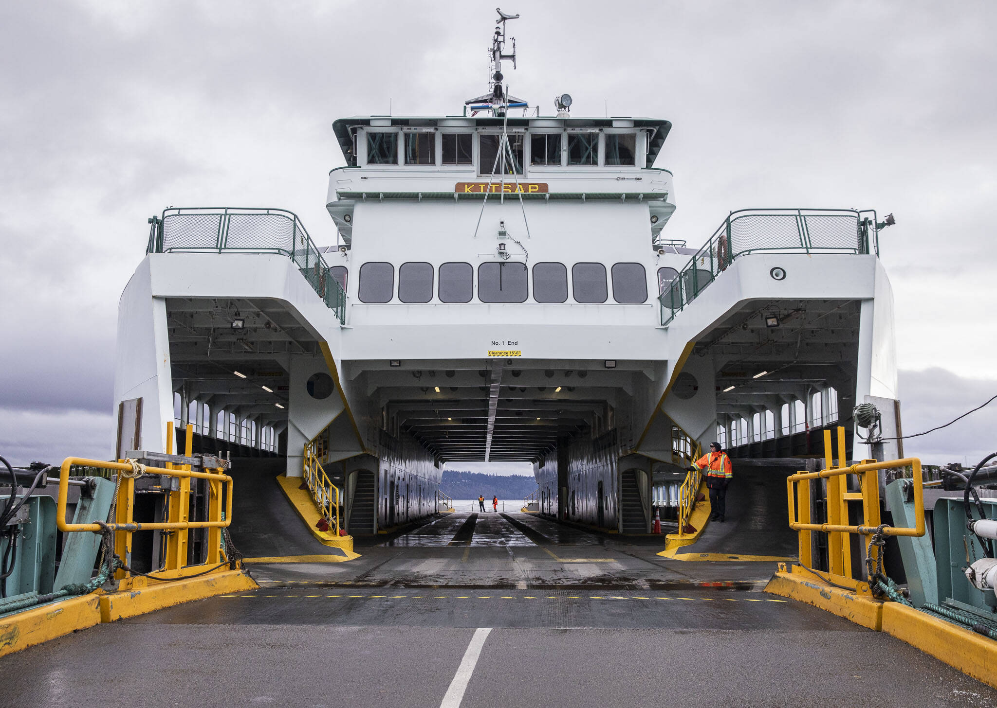 Ferry workers wait for cars to start loading onto the M/V Kitsap on Friday, Dec. 1, 2023 in Mukilteo, Washington. (Olivia Vanni / The Herald)