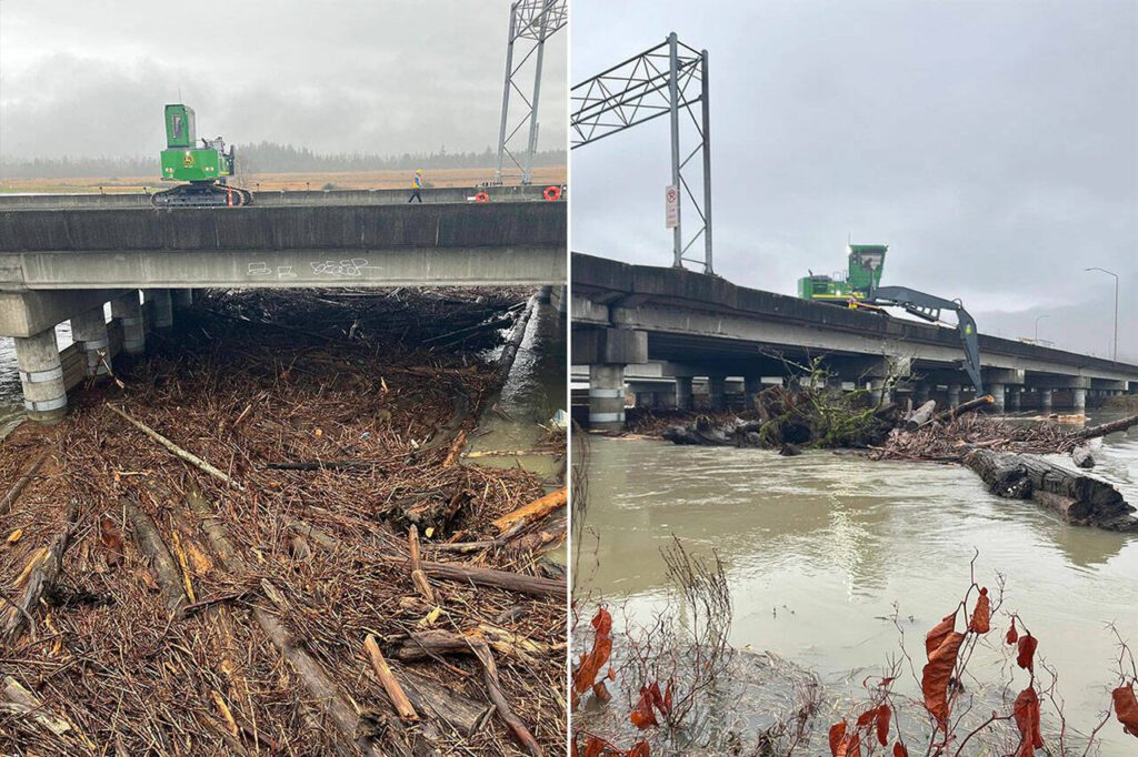 A loader on the U.S. 2 trestle over the Ebey Slough east of Everett, Washington on Thursday splits up wood debris as workers in boats push it down stream. (Washington State Department of Transportation)
