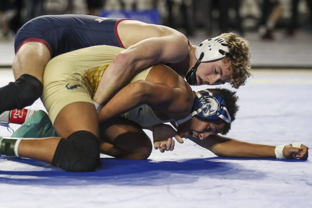 Arlington’s Tre Haines (bottom) wrestles Mount Spokane’s Hudson Buth during the Class 3A 138-pound championship match at Mat Classic XXXIV on Feb. 18 in Tacoma. (Annie Barker / The Herald)
