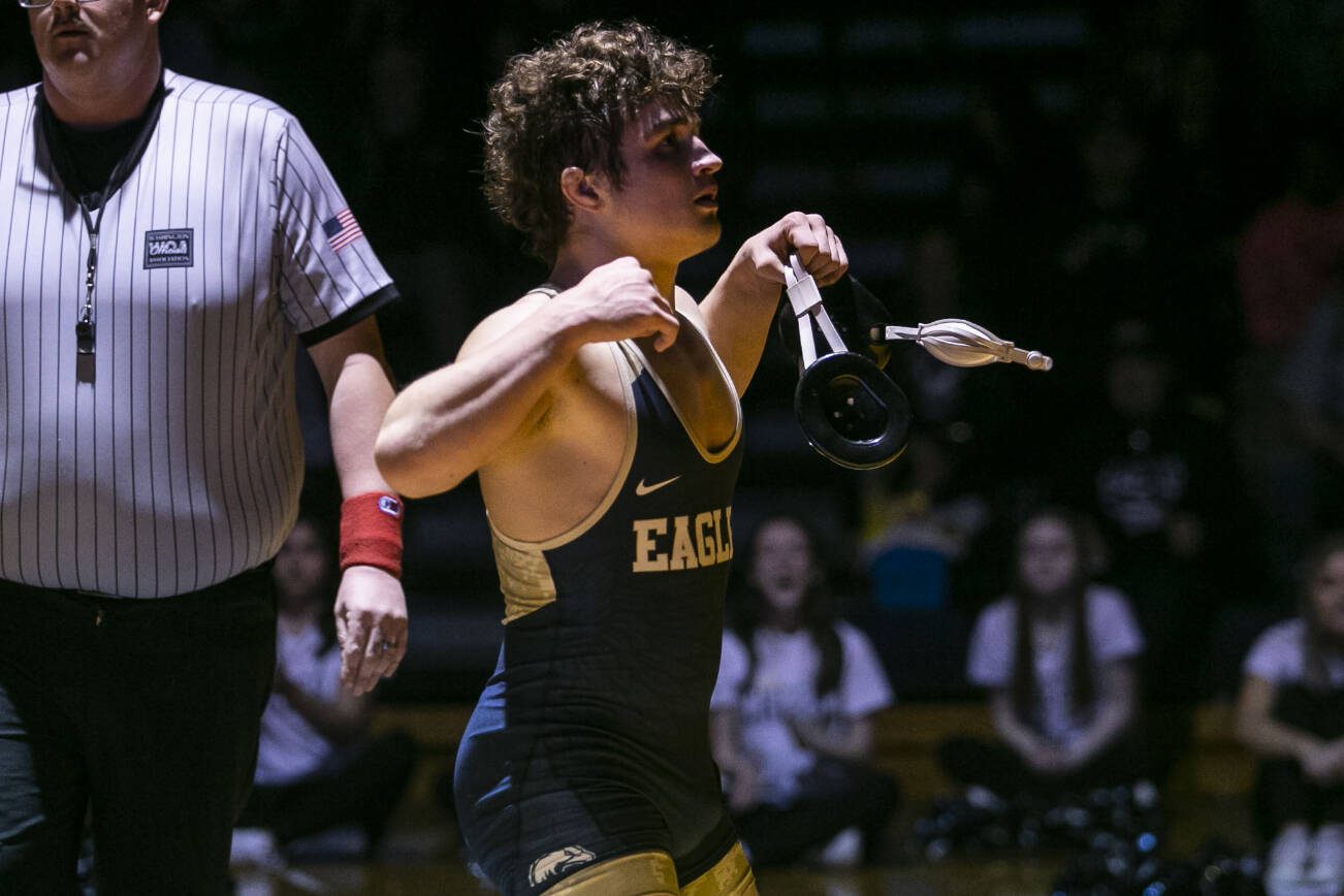 Arlington’s Dustin Baxter flexes after winning the 170 pound weight class match on Tuesday, Jan. 24, 2023 in Arlington, Washington. (Olivia Vanni / The Herald)