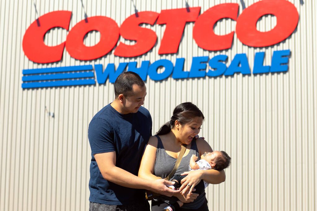 Angelo and Jona Sarmiento, along with 7-week-old Carlisle, stand in front of the Costco where Jona went into labor with the couple’s first child in late May on Friday, July 14, 2023, in Lake Stevens, Washington. (Ryan Berry / The Herald)
