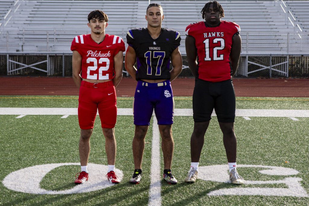 Left to right, Joseph Davis (22), Jayshon Limar (17), and Zaveon Jones (12) on Dec. 17 at Lake Stevens High School. (Annie Barker / The Herald)
