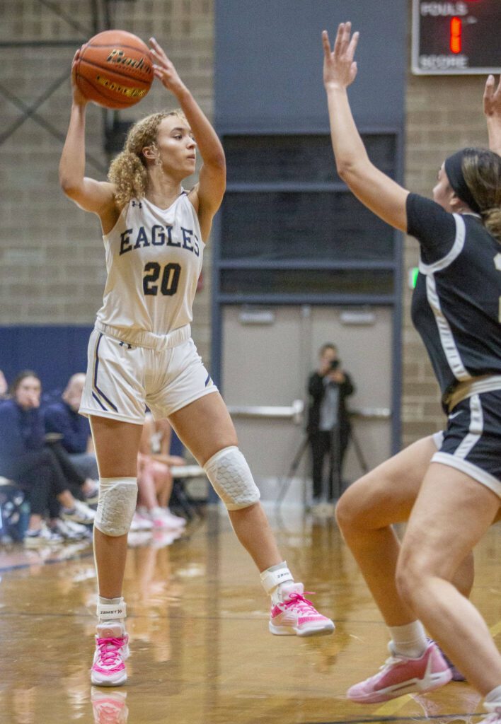 Arlington’s Samara Morrow jumps to make a pass during the game against Lynnwood on Monday, Dec. 11, 2023 in Arlington, Washington. (Olivia Vanni / The Herald)
