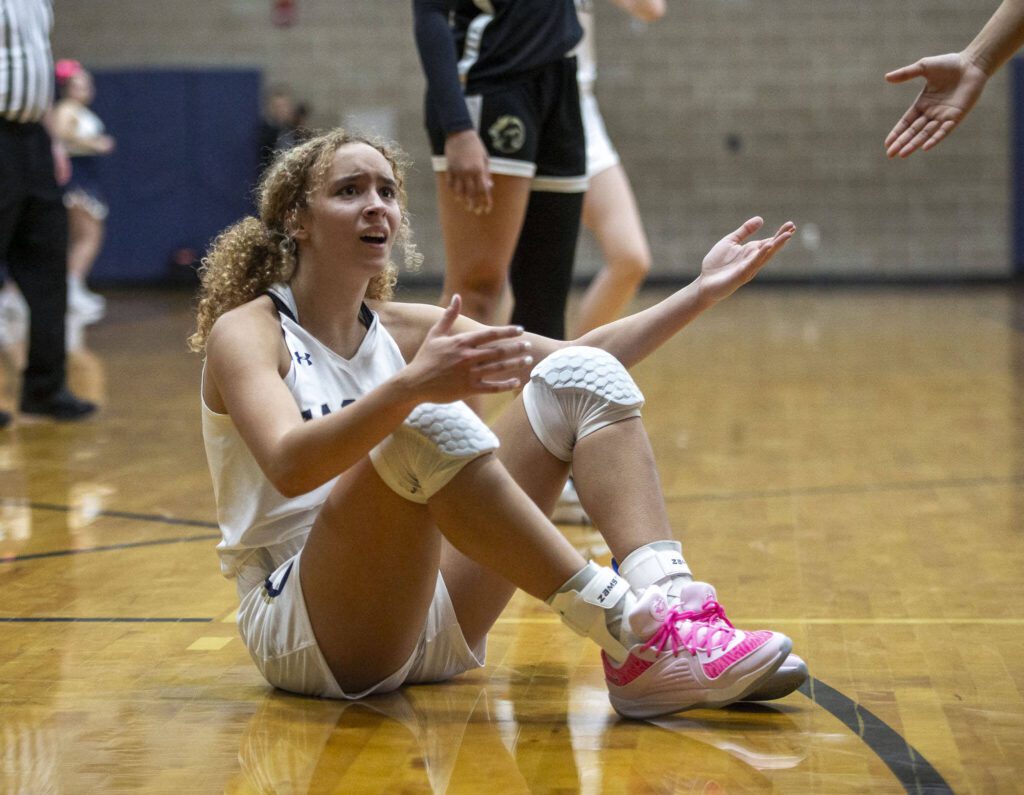Arlington’s Samara Morrow looks to the referee for a foul call during the game against Lynnwood on Monday, Dec. 11, 2023 in Arlington, Washington. (Olivia Vanni / The Herald)
