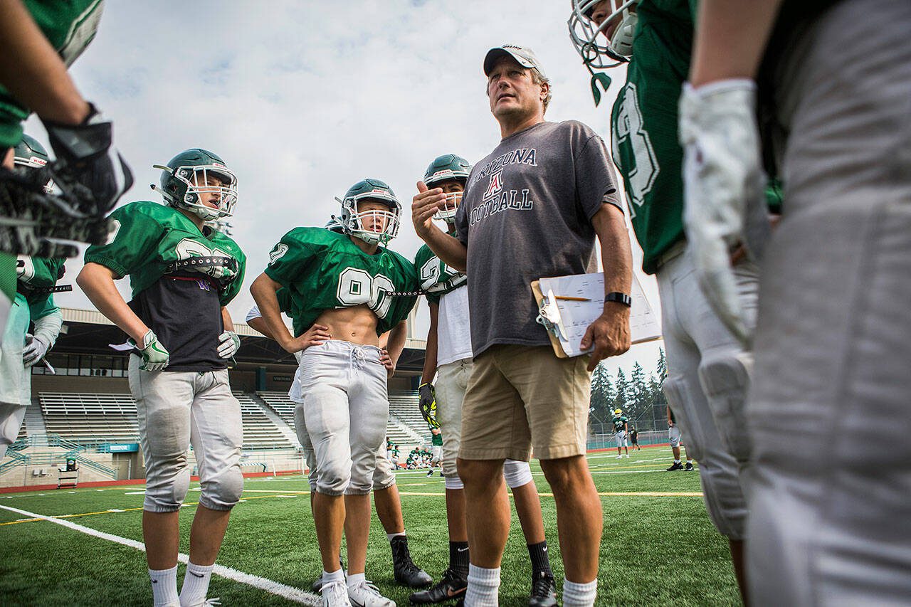 Edmonds-Woodway coach John Gradwohl, wearing his signature khaki shorts, talks to players during practice on Aug. 24, 2018, in Edmonds. (Olivia Vanni / The Herald)