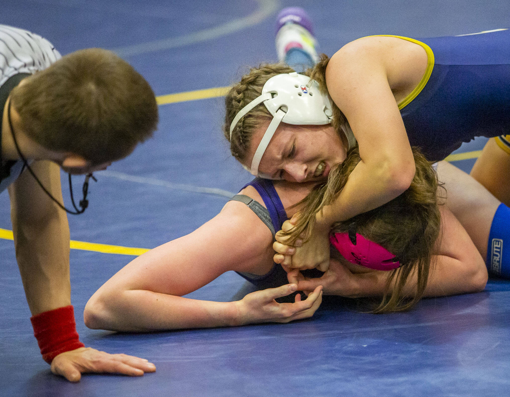 An Everett wrestler gets her opponent in a headlock on Wednesday, Dec. 13, 2023 in Everett, Washington. (Olivia Vanni / The Herald)