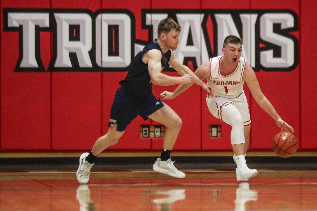 Everett Community College’s Ethan Martin (1) moves with the ball during a game against Tacoma on Dec. 9 at Everett Community College in Everett. Martin, a former Arlington High School star, now plays his home games on a court named for his grandfather, former longtime Trojans men’s basketball coach Larry Walker. (Annie Barker / The Herald)
