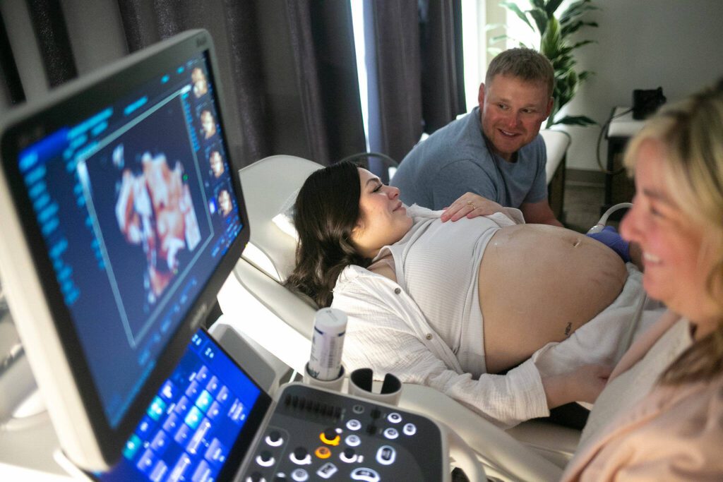 Franchesca and Don Simpson talk about their baby girl’s “chubby cheeks” and “button nose” as Kelly Fox performs a live-view 3D ultrasound on the expecting mother Saturday, Aug. 26, 2023, at Wonder Baby Ultrasound Studio in Everett, Washington. (Ryan Berry / The Herald)
