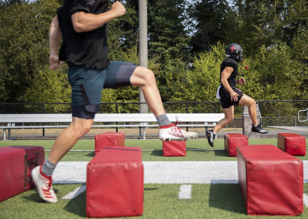 Archbishop Murphy football players run through warmups during practice on Aug. 24, 2023, in Everett, Washington. The new-look Wildcats were looking to embrace a youth movement under new head coach Joe Cronin after a winless season last fall. (Olivia Vanni / The Herald)
