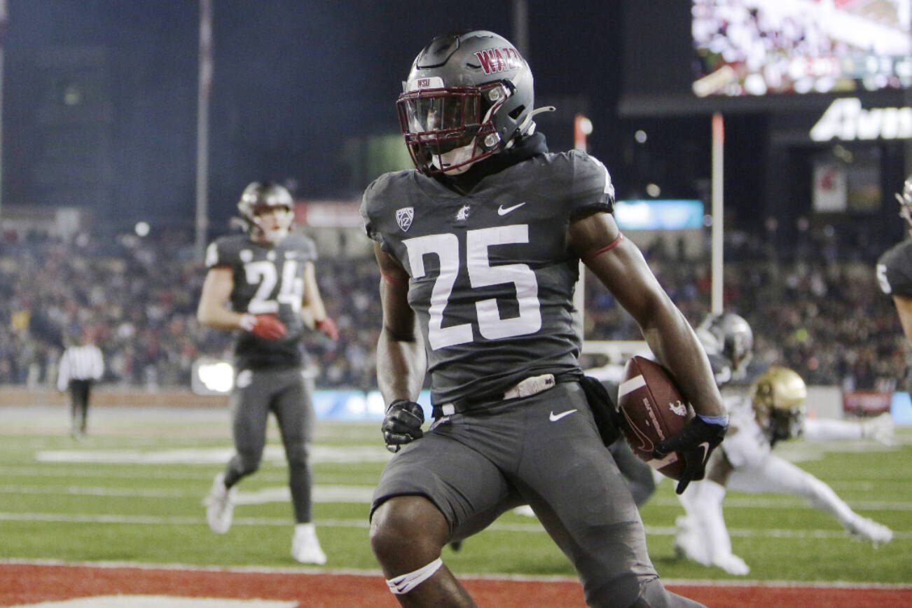 Washington State running back Nakia Watson (25) celebrates his touchdown during the first half of an NCAA college football game against Colorado, Friday, Nov. 17, 2023, in Pullman, Wash. (AP Photo/Young Kwak)