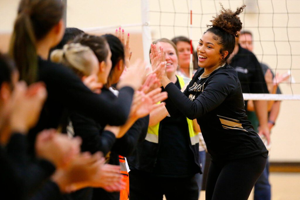 Lynnwood’s Hannah Johnson high-fives teammates before a match against Jackson on Sept. 14 at Lynnwood High School in Bothell. (Ryan Berry / The Herald)
